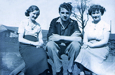 Alex sitting on a gate with the two daughters c.1937